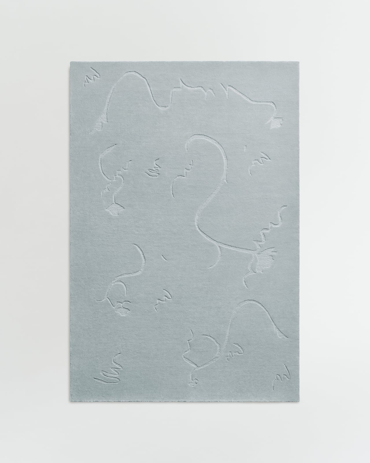 Dancing Flower rug by Nordic Knots, a pale blue-grey wool rug with a raised tone-on-tone floral line motif