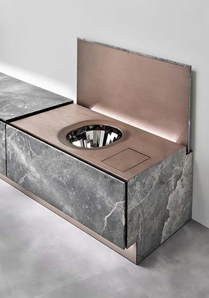 The Abaco system's marble-and-metal panel lifted open, revealing the polished steel bowl and integrated bidet fixture inside