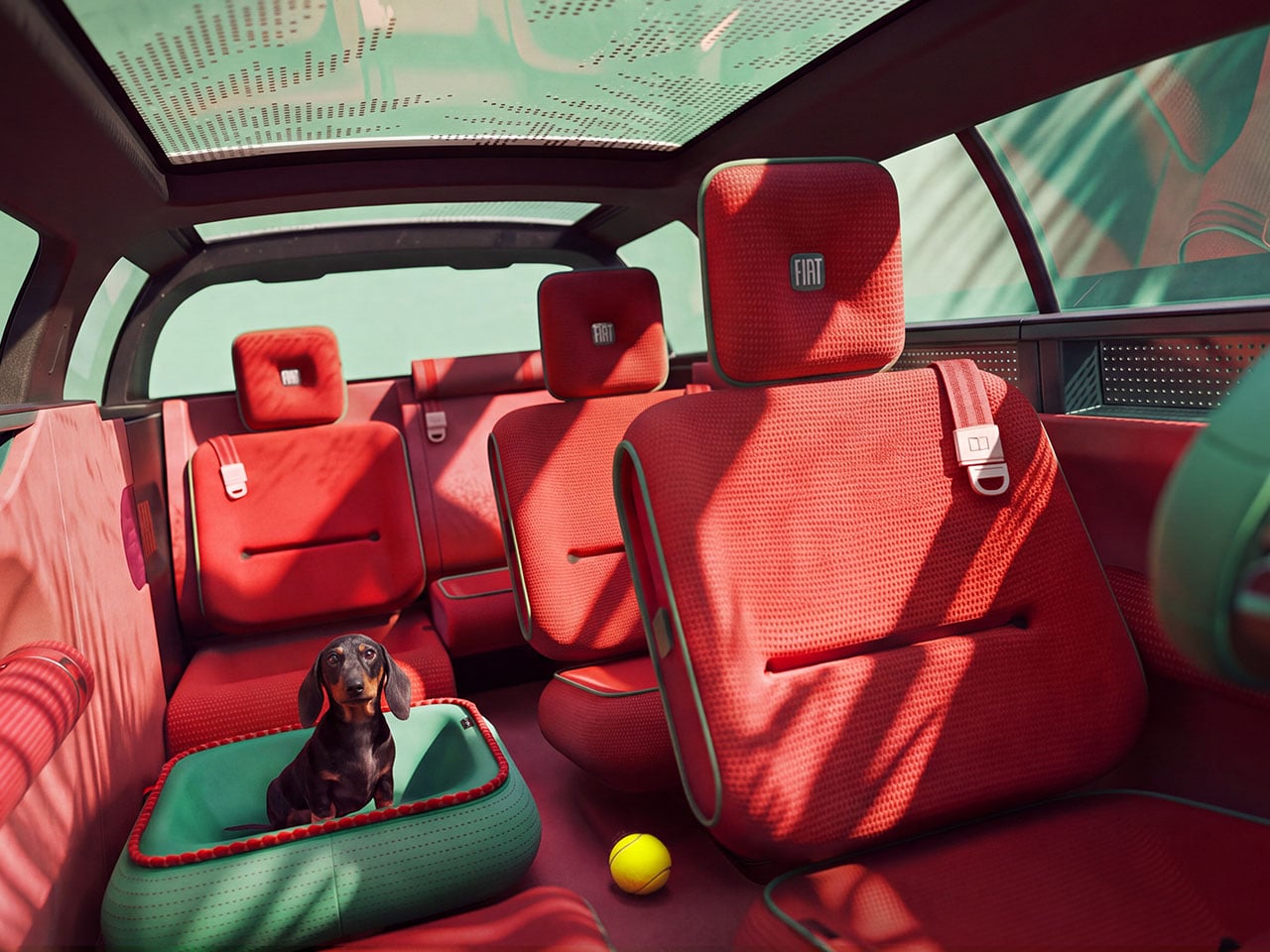 Interior view of the Fiat Multiplay with a dachshund sitting in the Petsenger pet bed built into the rear seating area