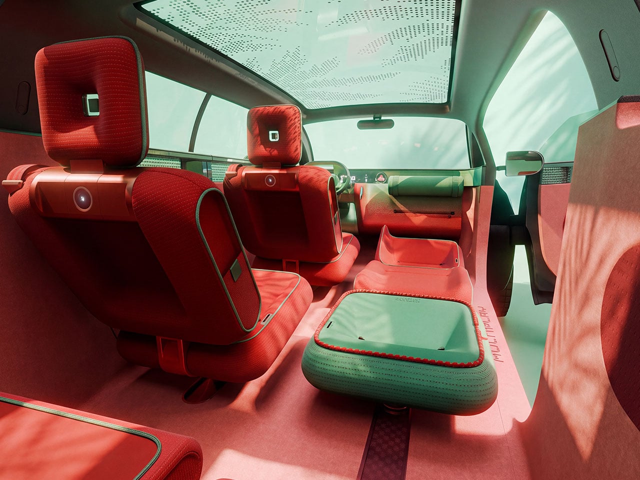 Interior view through the Fiat Multiplay's open tailgate, showing the rear seats, a green fold-out storage tray and the cargo bed beyond