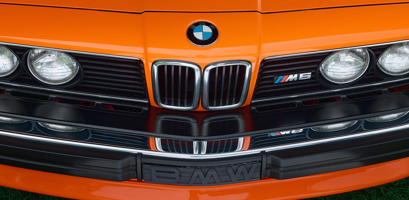 A close-up of the restored M6's grille and headlights, badged with the original M6 emblem