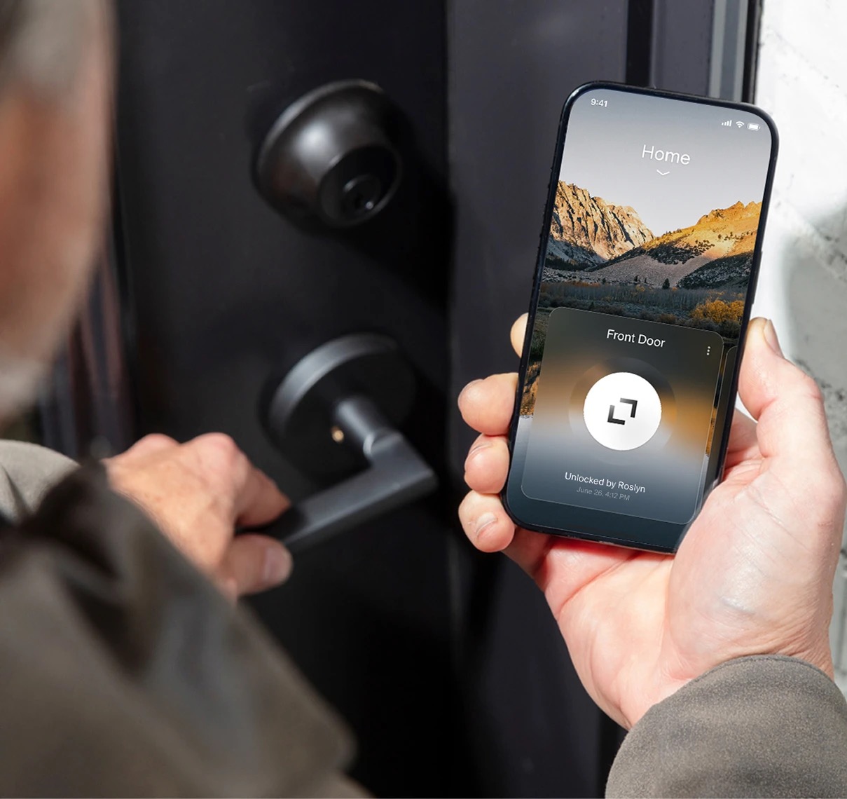 A hand holding a phone showing the Level app's unlock activity log — "Unlocked by Roslyn, June 26, 4:12 PM" — next to the Level Lock Pro's deadbolt cylinder and lever handle on a black door