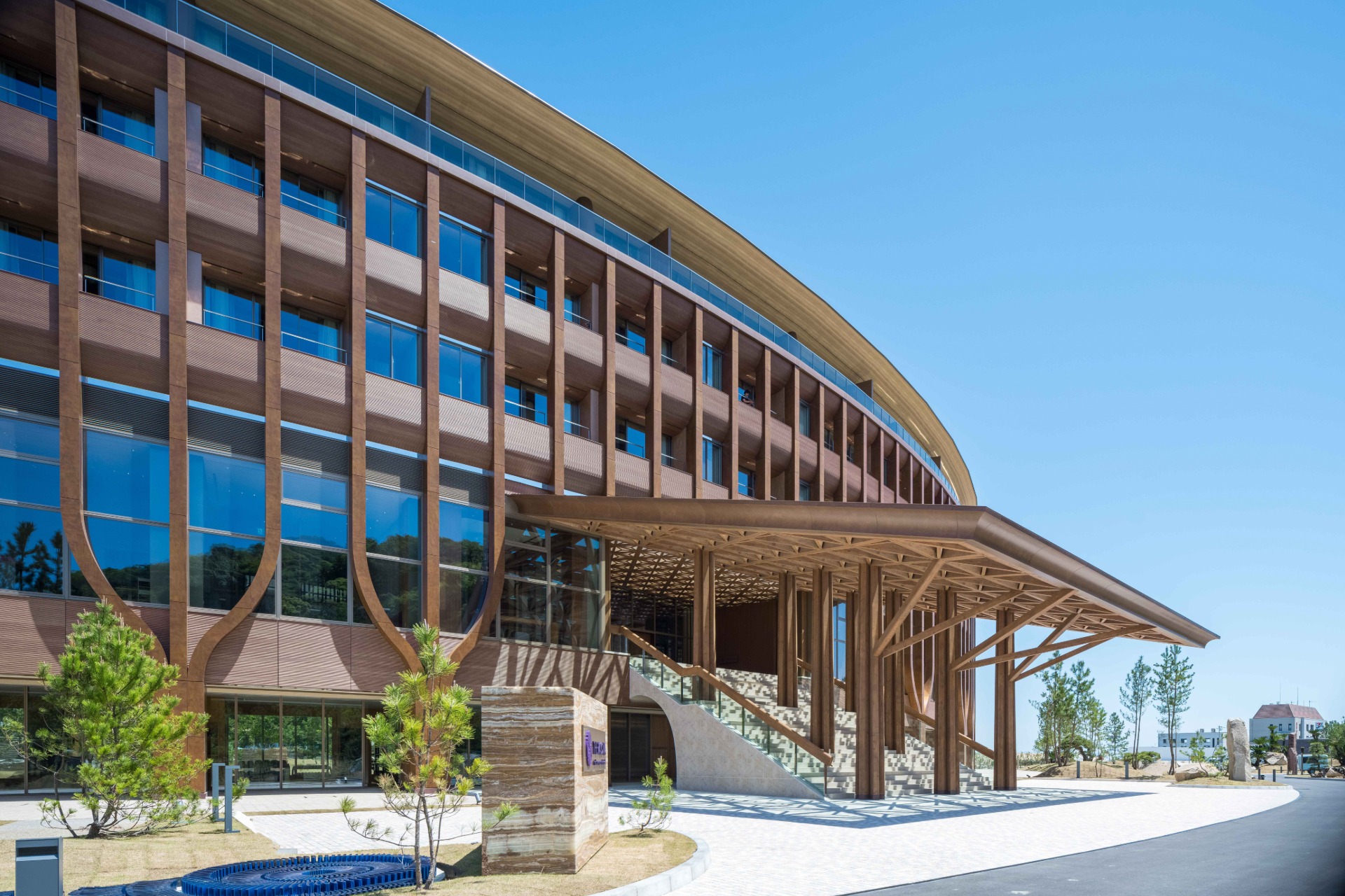 The asanoha-patterned timber canopy over THE PASONA's entrance stairway