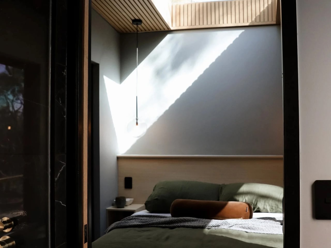 SHAK bathroom with brass rainfall showerheads opening onto the bush